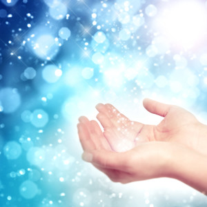 Hands catching stardust symbolize the healing touch of joy. 