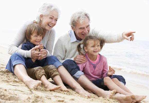 Grandparents and Grandchildren Relax Together at Seashore.